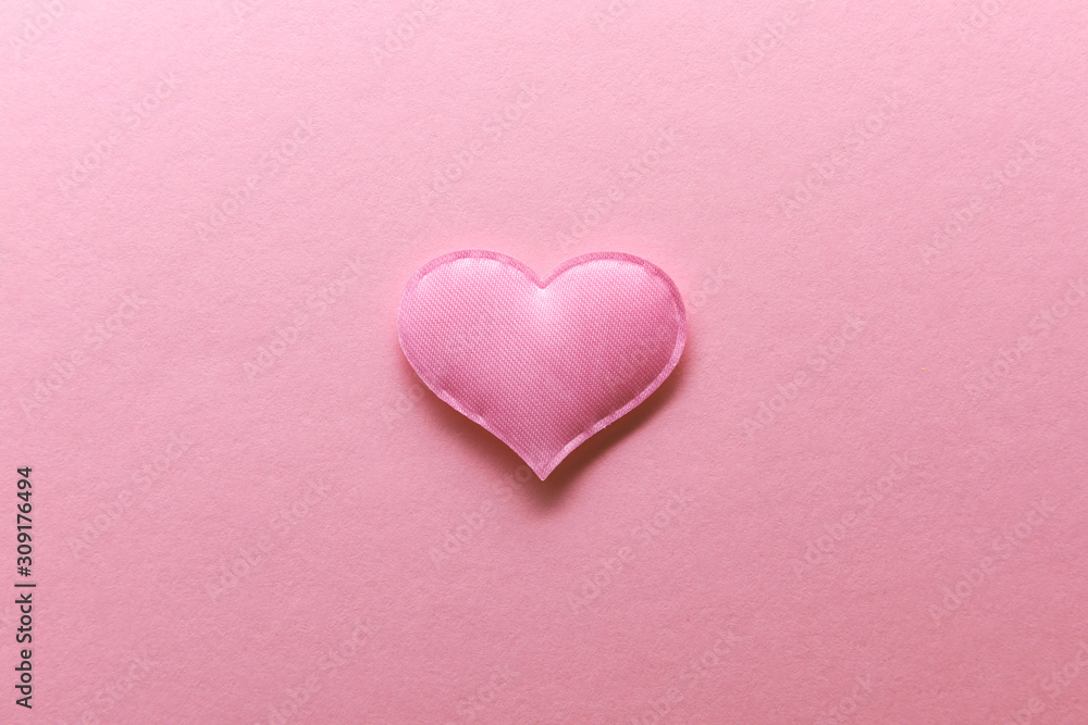 Pink textile heart on pink background. Valentines day texture and love concept