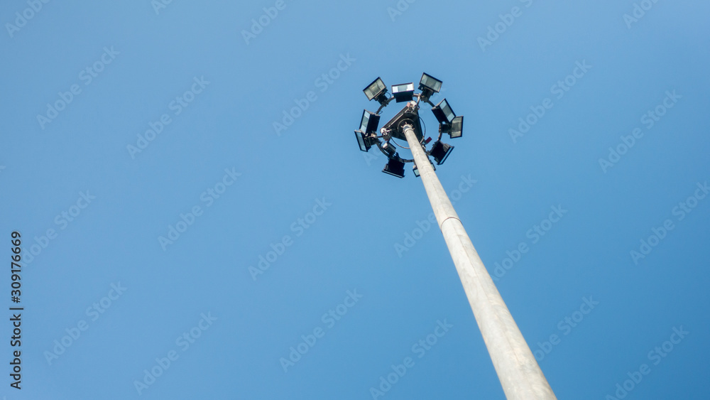 Sport light on blue sky background.