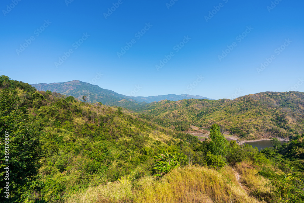 Fototapeta premium beautiful blue sky high peak mountains mist fog wildlife green forest at Khao Koh Phu Tub Berk Phetchabun Thailand guiding idea long weekend for backpacker camping campfire relaxing hiking 