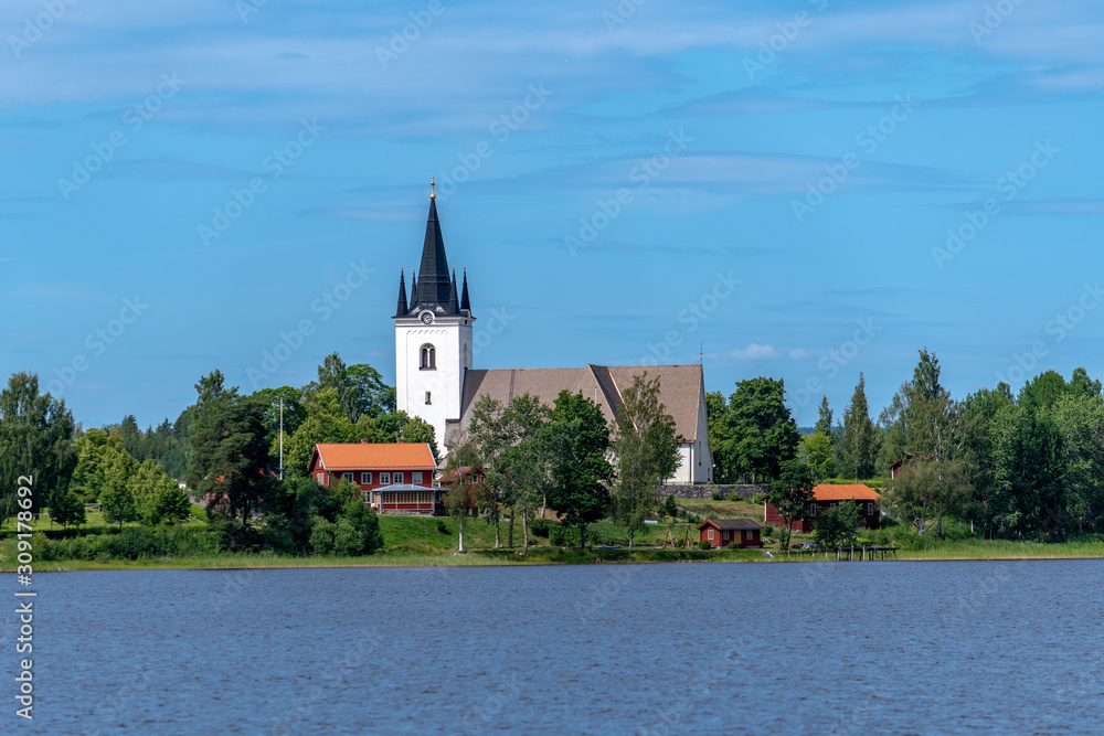 The beautiful church of Svardsjo in Sweden from across the lake