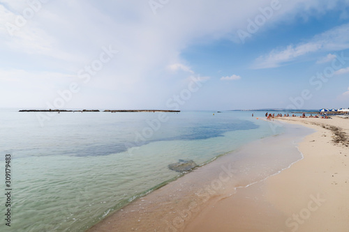 Sandy beach against blue sky and azure sea