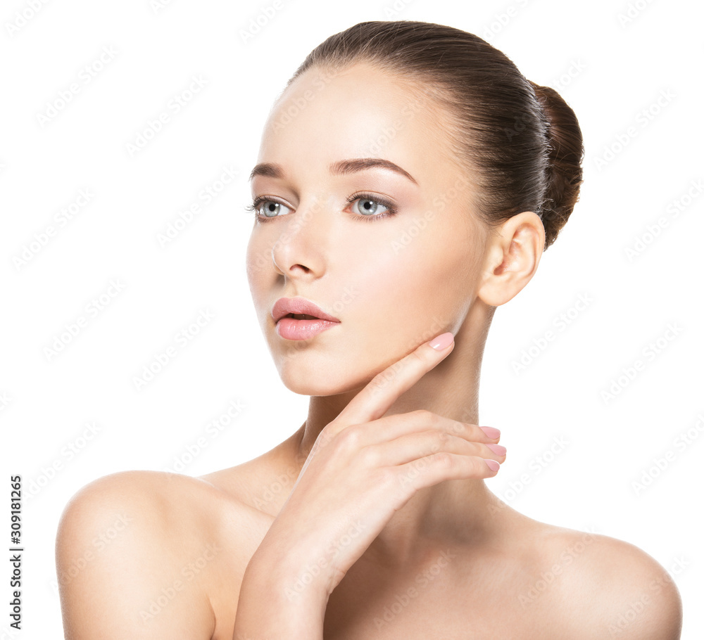 Young woman with healthy clean skin touches the face. Skin care concept.