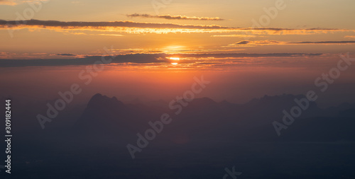Sunrise landscape with shadow of mountain and cloudy sky in the morning 