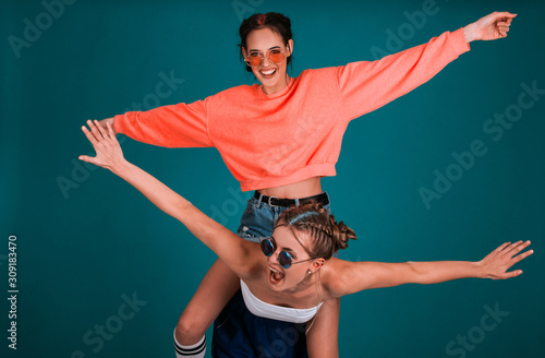two teen female models, cute girls, best friends concept, having fun, hanging out, smiling, indoor photo