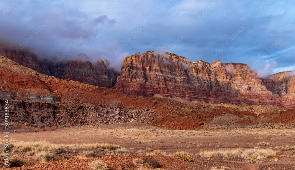 Towering Red Rock Cliffs In Northern Arizona with Clouds