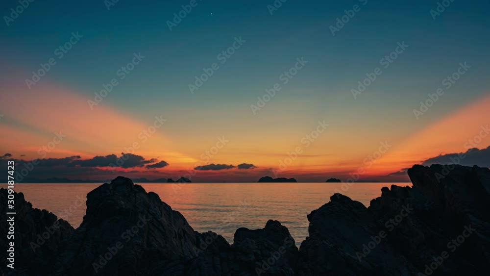 Spectacular sunset over rocks on the beach. 4k time lapse Spectacular sunset over rocks on the beach. 4k time lapse