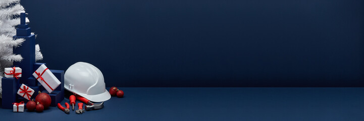Construction tools, hard hat and Christmas decorations. Christmas and New Year construction.  Extra wide banner background