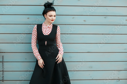 Fashion woman posing against a plain wall. Copy space. © ElenaBatkova