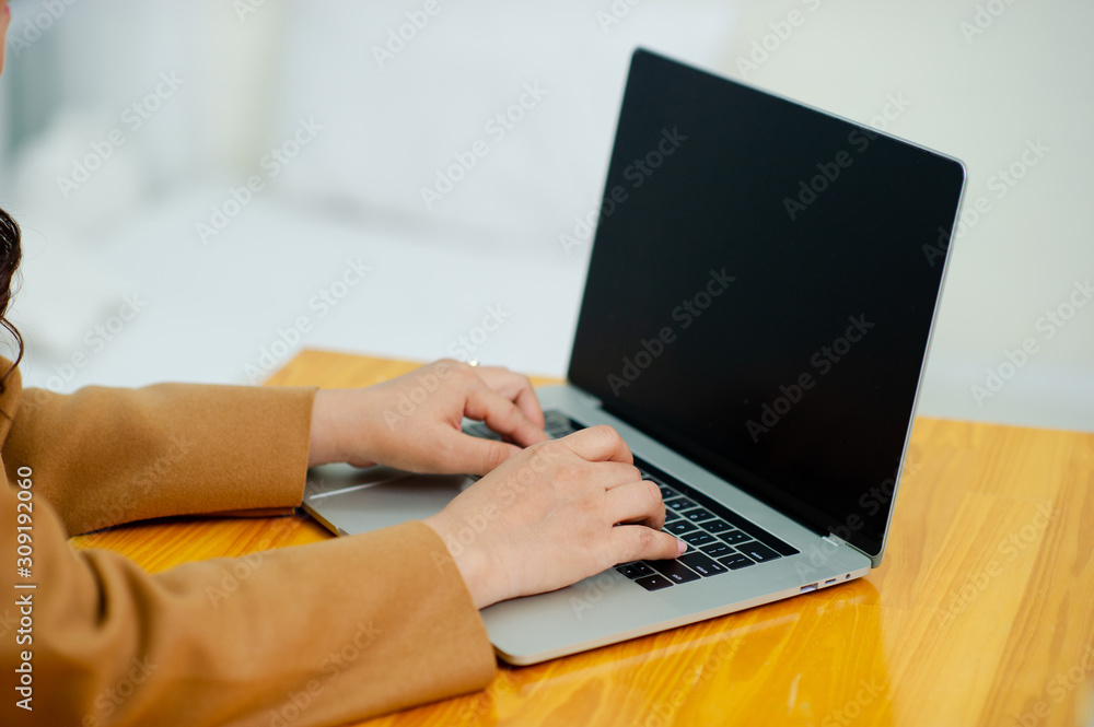 Woman using a laptop, searching the web, browsing information, having a workplace at home Doing business online at home. Online business concepts Woman using a laptop, searching the web, browsing information, having a workplace at home Doing business online at home. Online business concepts