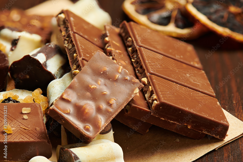 Chocolate bars and homemade candies on rustic table, sweet food, macro photo Chocolate bars and homemade candies on rustic table, sweet food, macro photo