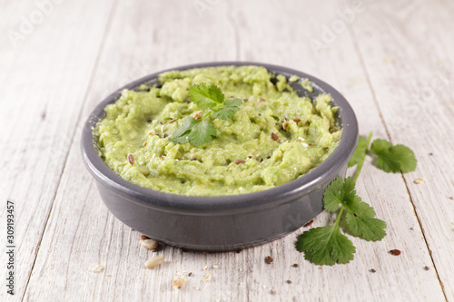 homemade guacamole with coriander herb in bowl,