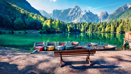 Crédence de cuisine Photos Six pleasure boats on Fusine lake. Spectacular morning scene of Julian Alps with Mangart peak on background, Province of Udine, Italy, Europe. Traveling concept background.  © Andrew Mayovskyy