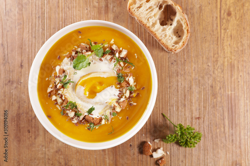 pumpkin soup with cream and nuts in bowl