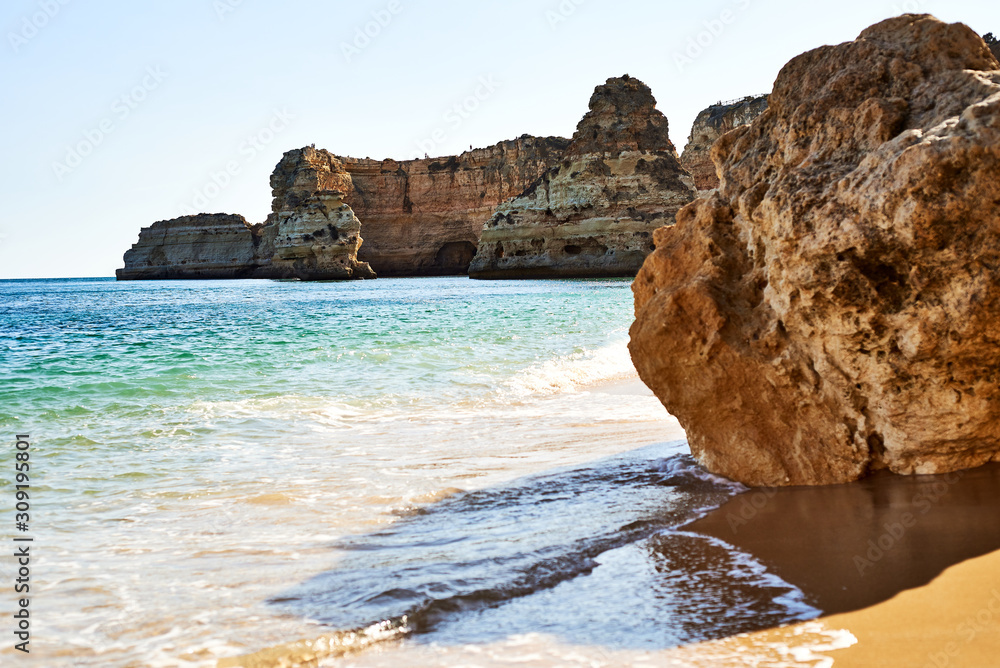 Rocks, sandy beach in Portugal, Atlantic coast, Algarve.