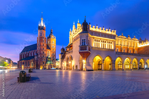 Medieval Main market square with Basilica of Saint Mary and Cloth Hall in Old Town of Krakow at sunrise, Poland
