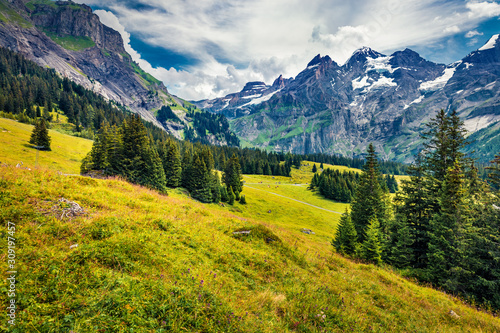 Dramatic summer view of mountain valley from the Oeschinen Lake. Gorgeous morning scene of Swiss Alps, Kandersteg village location, Switzerland, Europe. Beauty of nature concept background. © Andrew Mayovskyy