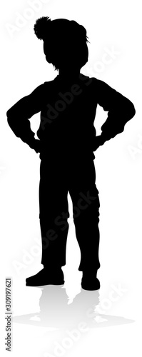 A child in silhouette playing in Christmas or winter cold weather clothing