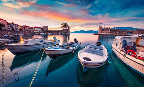 Fototapeta Naklejka Na Ścianę i Meble -  Sunrise in popular touristic destination - Nafpaktos port. Fantastic morning view of Gulf of Corinth, Greece, Europe. Fantastic seascape of Ionian sea. Traveling concept background.