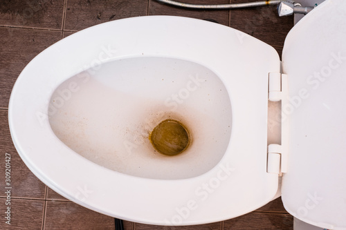 Dirty unhygienic and unclean toilet bowl in a restroom.