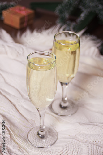 Two glasses of champagne on a white fur plaid