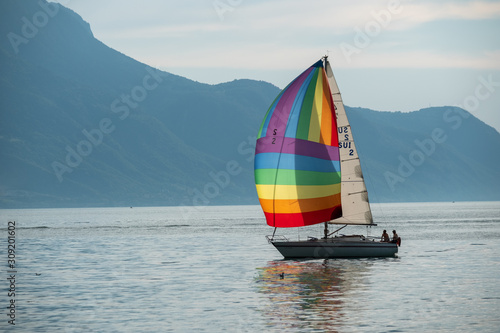 Yacht with rainbow sail in Geneva lake
