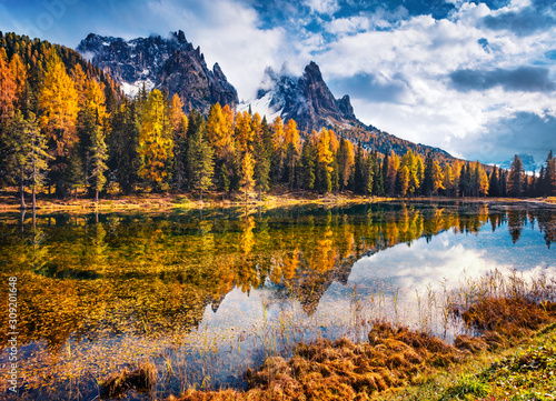 Colorful morning view of Dolomite Alps, Province of Belluno, Italy, Europe. Dramatic autumn scene of Antorno lake. Beauty of nature concept background.