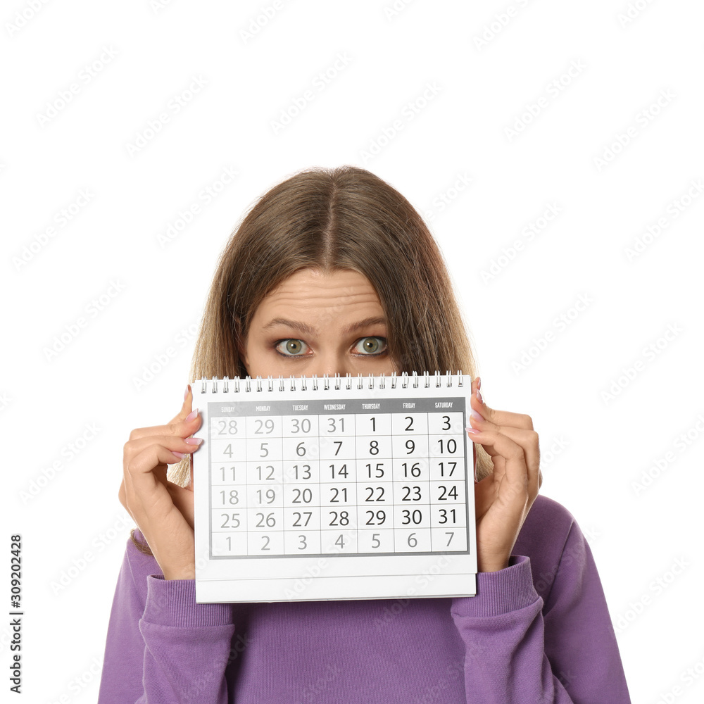 Young woman holding calendar with marked menstrual cycle days on white background Young woman holding calendar with marked menstrual cycle days on white background