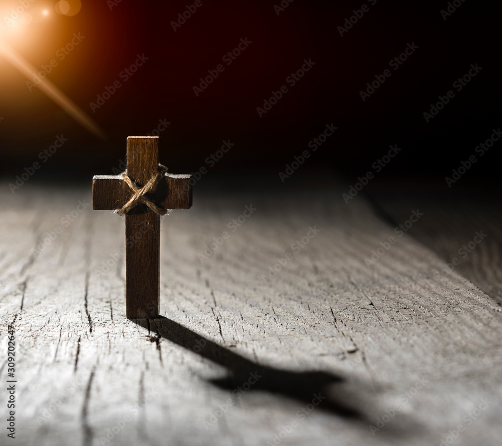 Wooden cross on dark background with copy space. Wooden cross on dark background with copy space.