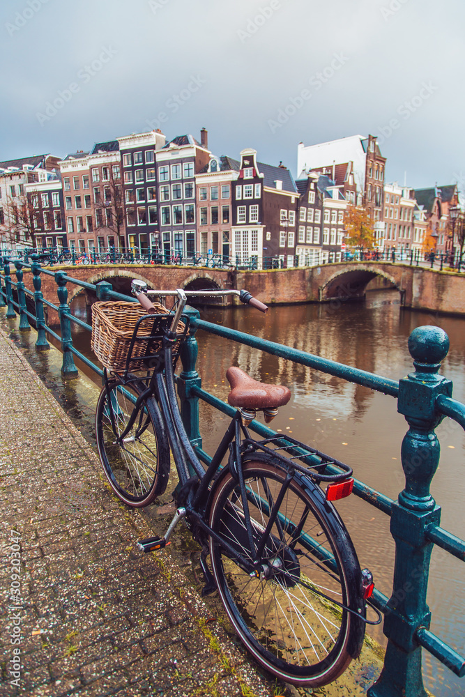 Fototapeta premium Bicycle parked on a bridge in Amsterdam, Netherlands
