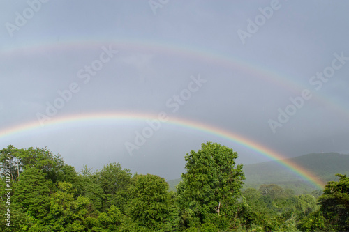 Fototapeta Naklejka Na Ścianę i Meble -  A double rainbow is seen in the sky after a strong storm moves through the mountains of Virginia.