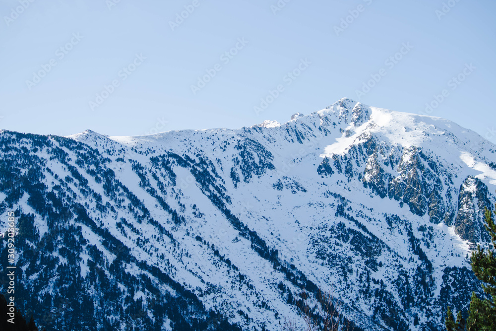 Andorra valley with snowy pyrenees mountains on a sunny day