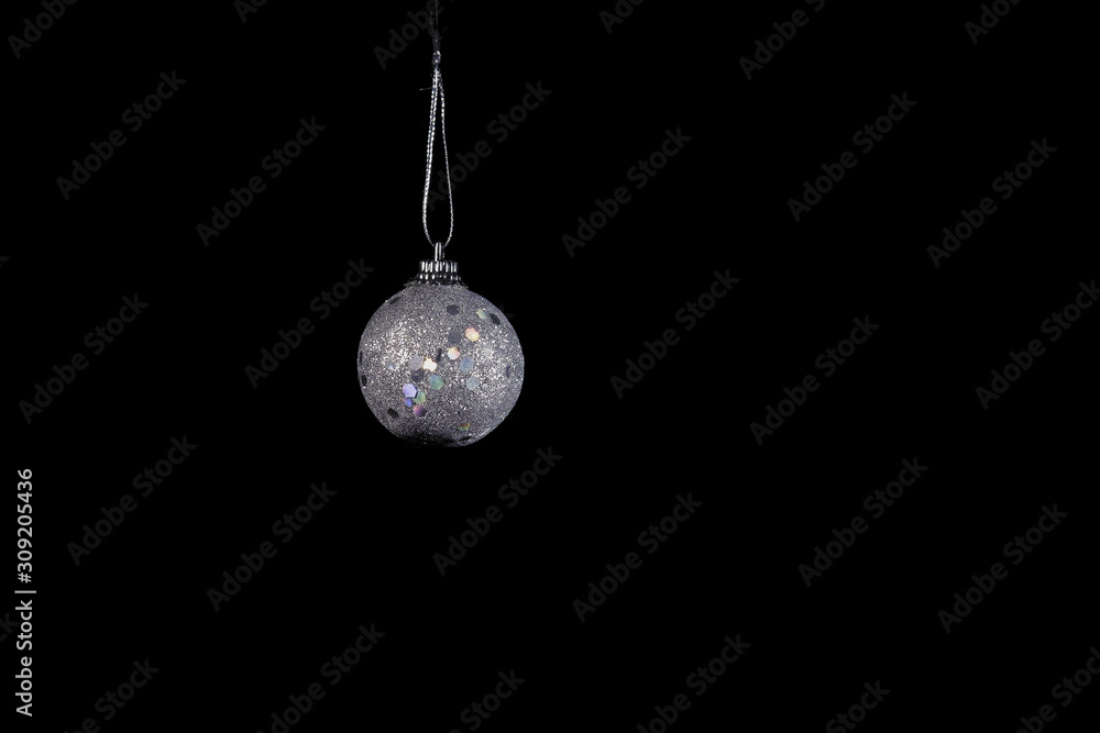 Silver Christmas tree ball on a black background