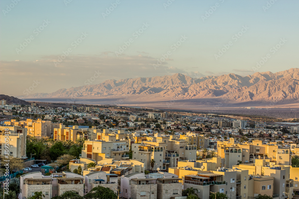 Middle East the most south Israeli city Eilat aerial landmark urban view on buildings and street with sand stone picturesque mountain ridge in Jordan Gulf of Aqaba region