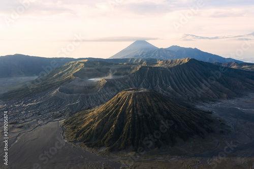 View from above, stunning aerial view of the Mount Batok and the Mount Bromo illuminated at sunset. Mount Bromo is an active volcano in East Java, Indonesia.