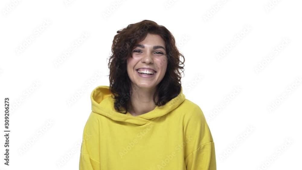 Cheerful attractive young glad woman in yellow hoodie, nice girl laughing and smiling joyfully, watching funny movie, having hilarious conversation, heard joke, giggle entertained, yellow background Cheerful attractive young glad woman in yellow hoodie, nice girl laughing and smiling joyfully, watching funny movie, having hilarious conversation, heard joke, giggle entertained, yellow background
