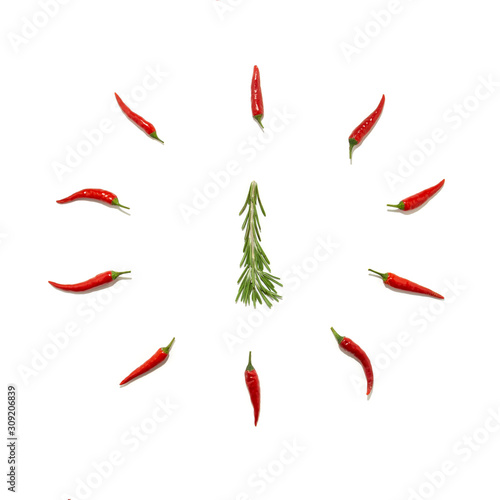 Abstract Christmas background in the form of a clock and a fir tree made of rosemary and chili pepper on a white background. Food concept, Christmas minimalism