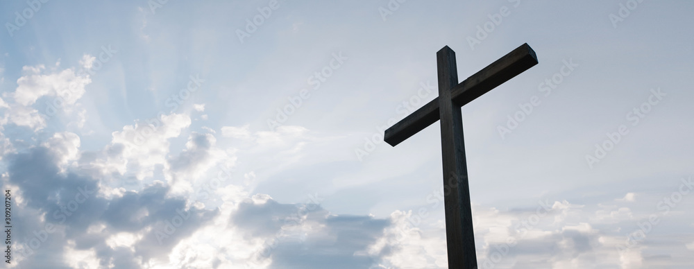 Wooden cross over sunrise background Wooden cross over sunrise background