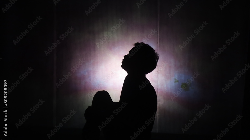 silhouette of man in darkness
