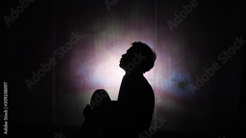 silhouette of man in darkness