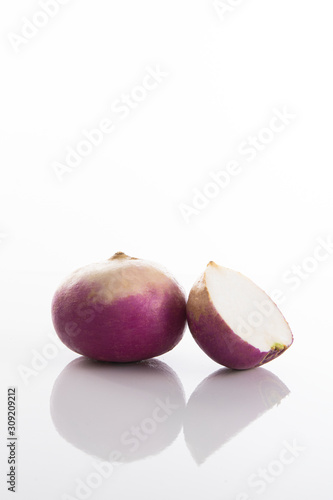 Fresh radish on a white surface with a white background