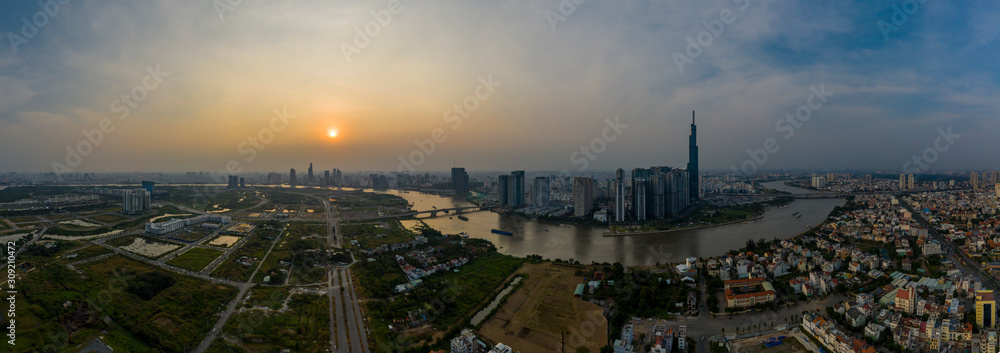 Smoggy Sunset Panorama over Saigon River in Ho Chi Minh City, Vietnam featuring the City Skyline Smoggy Sunset Panorama over Saigon River in Ho Chi Minh City, Vietnam featuring the City Skyline