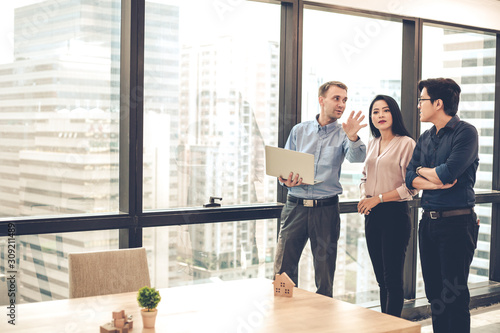 House sales representatives are taking customers to see and offer houses that are selling.