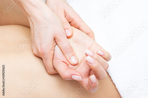 Young woman having arm massage in beauty salon  close up view