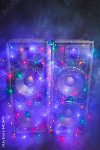 music speakers with festive Christmas lights and smoke