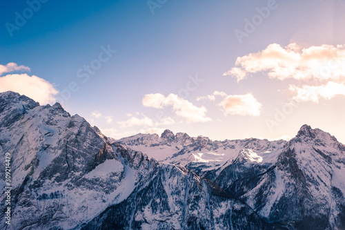 Snow-covered mountains at sunset. Dolomite Alps. Val Di Fassa, Italy. Beautiful winter landscape