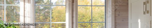 Bright interior, room in wooden house with large window. Banner. Scandinavian style.