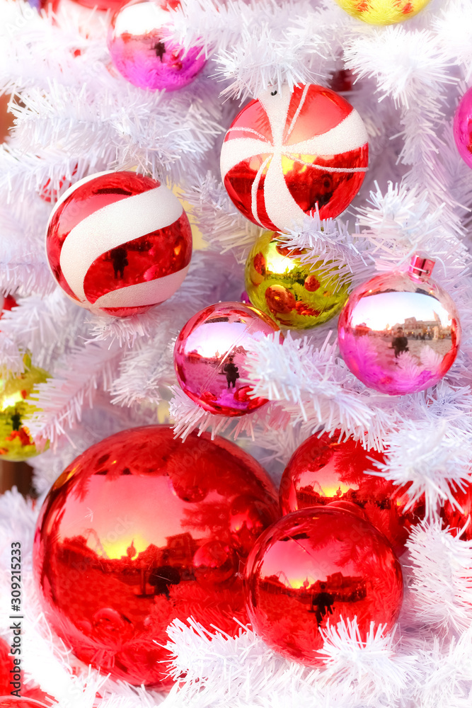 Shiny Christmas balls decorated on white Christmas tree