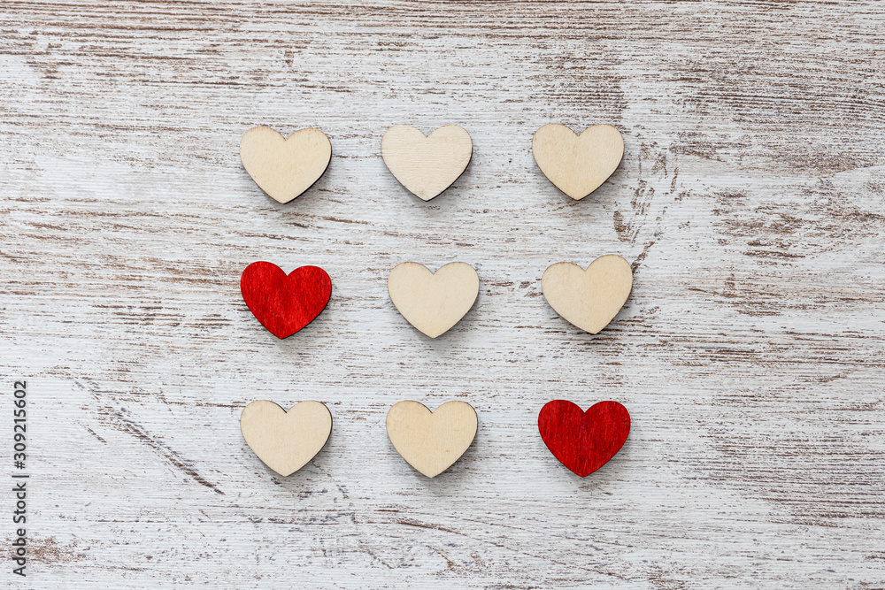 Fototapeta premium Red and white hearts on a wooden background. Valentines day concept