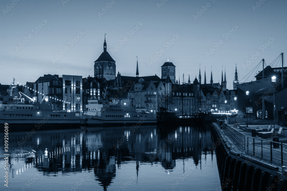 Evening view of the city river embankment, trendy monochrome classic blue toning