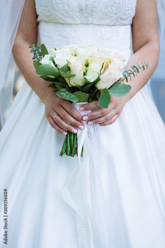 wedding bouquet of flowers in the hands of the bride wedding bouquet of flowers in the hands of the bride